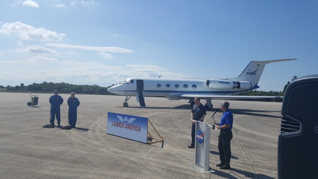 From left, Demo-2 crew members Robert Behnken and Douglas Hurley, NASA Administrator Jim Bridenstine and Kennedy Space Center Director Bob Cabana speak to members of the media on May 20, 2020, at the Launch and Landing Facility runway following the crew's arrival to the Florida spaceport.