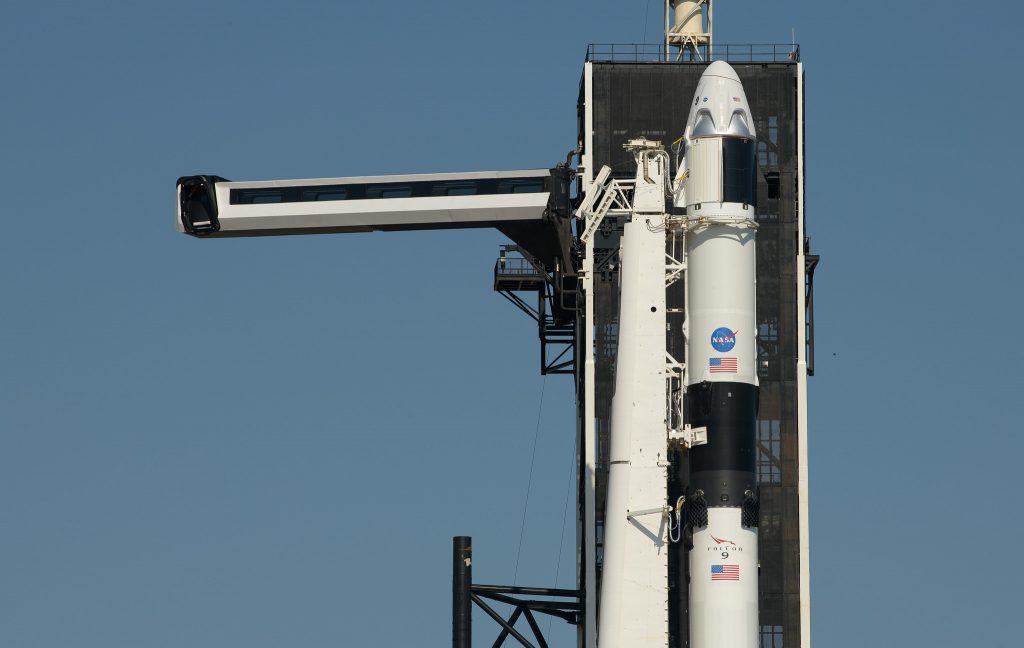 The crew access arm is swung into position for the Crew Dragon spacecraft and the SpaceX Falcon 9 rocket at Launch Complex 39A as preparations continue for the Demo-2 mission, Thursday, May 21, 2020, at NASA's Kennedy Space Center in Florida.