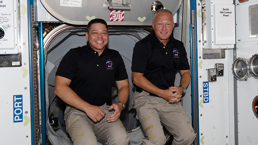 The International Space Station's two newest crew members, NASA astronauts (from left) Bob Behnken and Doug Hurley, are pictured having just entered the orbiting lab shortly after arriving aboard the SpaceX Crew Dragon spacecraft. Credits: NASA