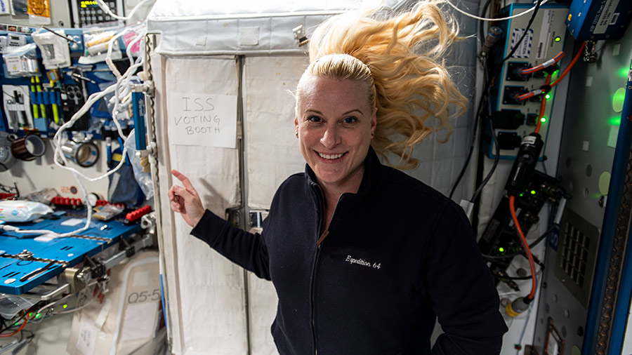 NASA astronaut and Expedition 64 Flight Engineer Kate Rubins points to the International Space Station's