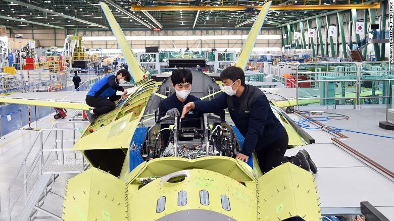 A handout photo released by KAI shows workers of Korea Aerospace Industries (KAI) assemble the first prototype of South Korea's indigenous fighter jet at its plant in the southeastern city of Sacheon, South Korea in January.