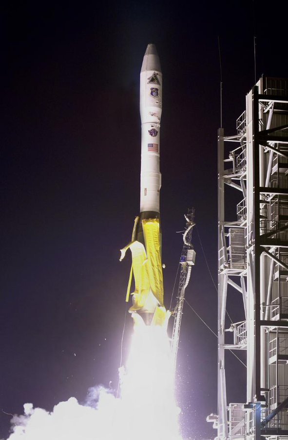 Minotaur I rocket launching at night.