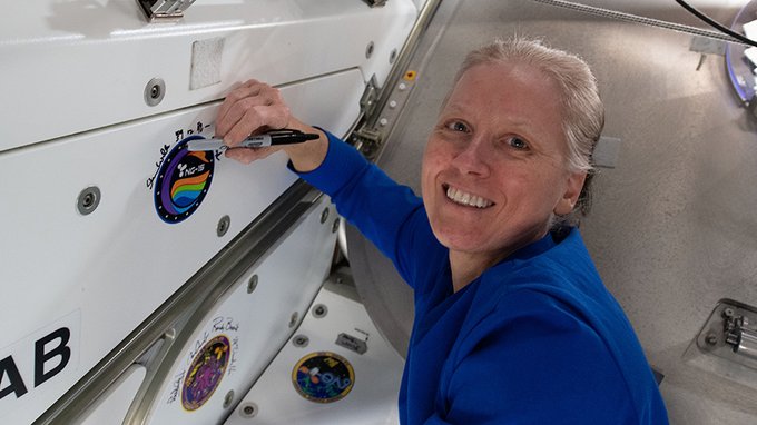 NASA astronaut Shannon Walker, seen here signing the Unity module's vestibule that leads to the Cygnus space freighter, will command the station till her departure at the end of April.