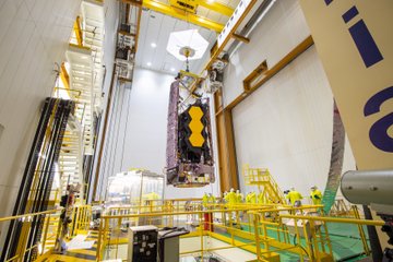 Webb is hoisted to align on top the Ariane 5 rocket.