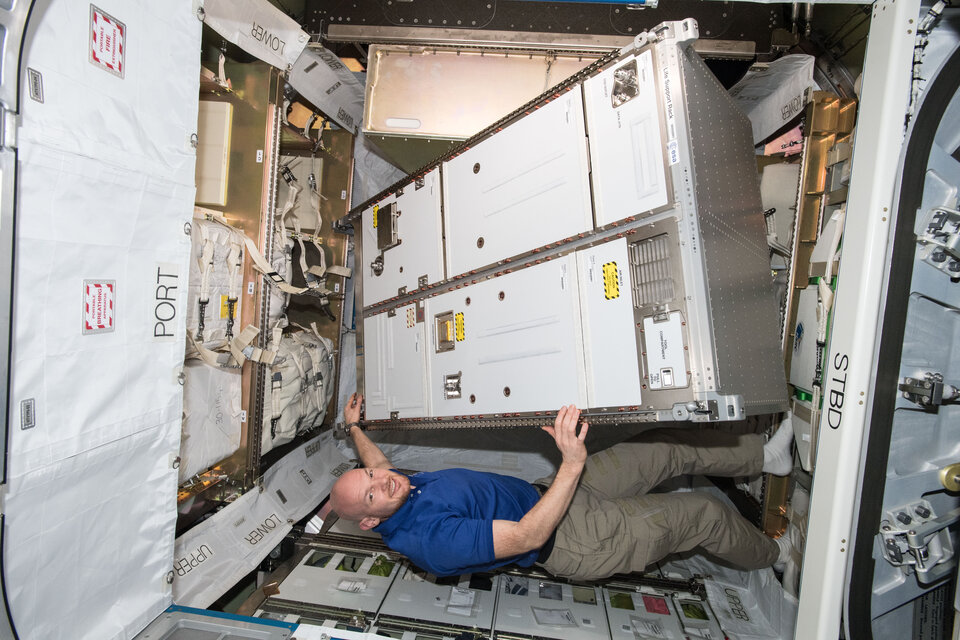 ESA astronaut installing standard-sized Space Station rack