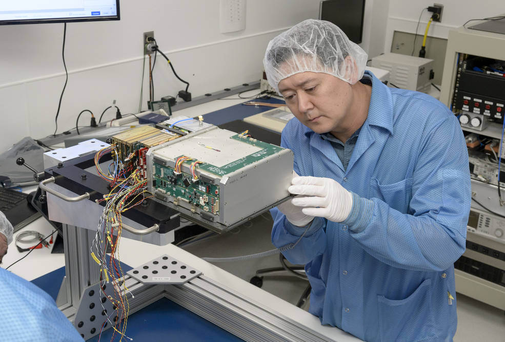 Integration and test engineer, Dan Rowan, works on internal components of BioSentinel's CubeSat.