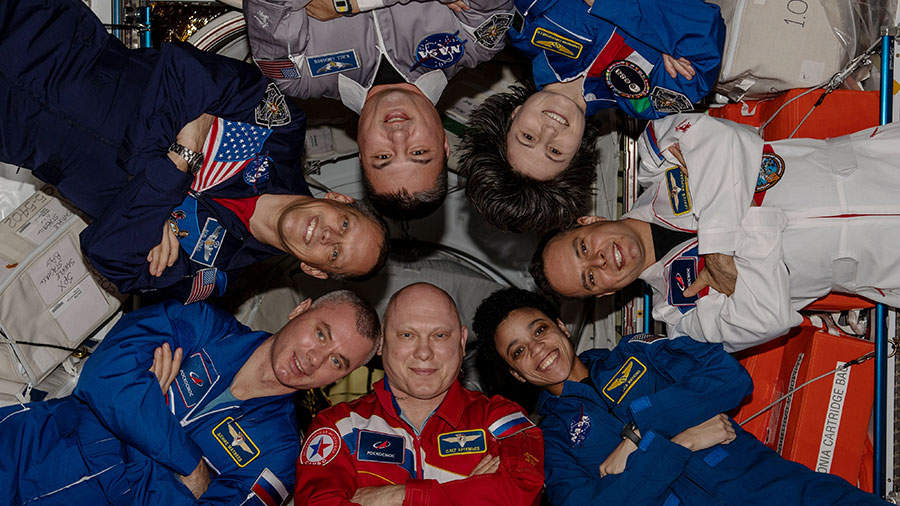 The seven-member Expedition 67 crew poses for a portrait inside the International Space Station's Harmony module.