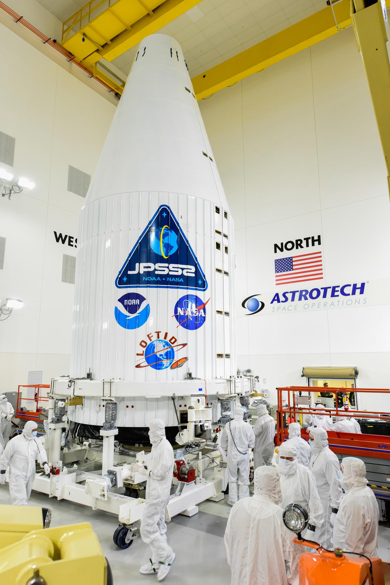 Technicians check the United Launch Alliance Atlas V payload fairing containing the National Oceanic and Atmospheric Administration's (NOAA) Joint Polar Satellite System-2 (JPSS-2) inside the Astrotech Space Operations facility at Vandenberg Space Force Base (VSFB) in California on Oct. 12, 2022.