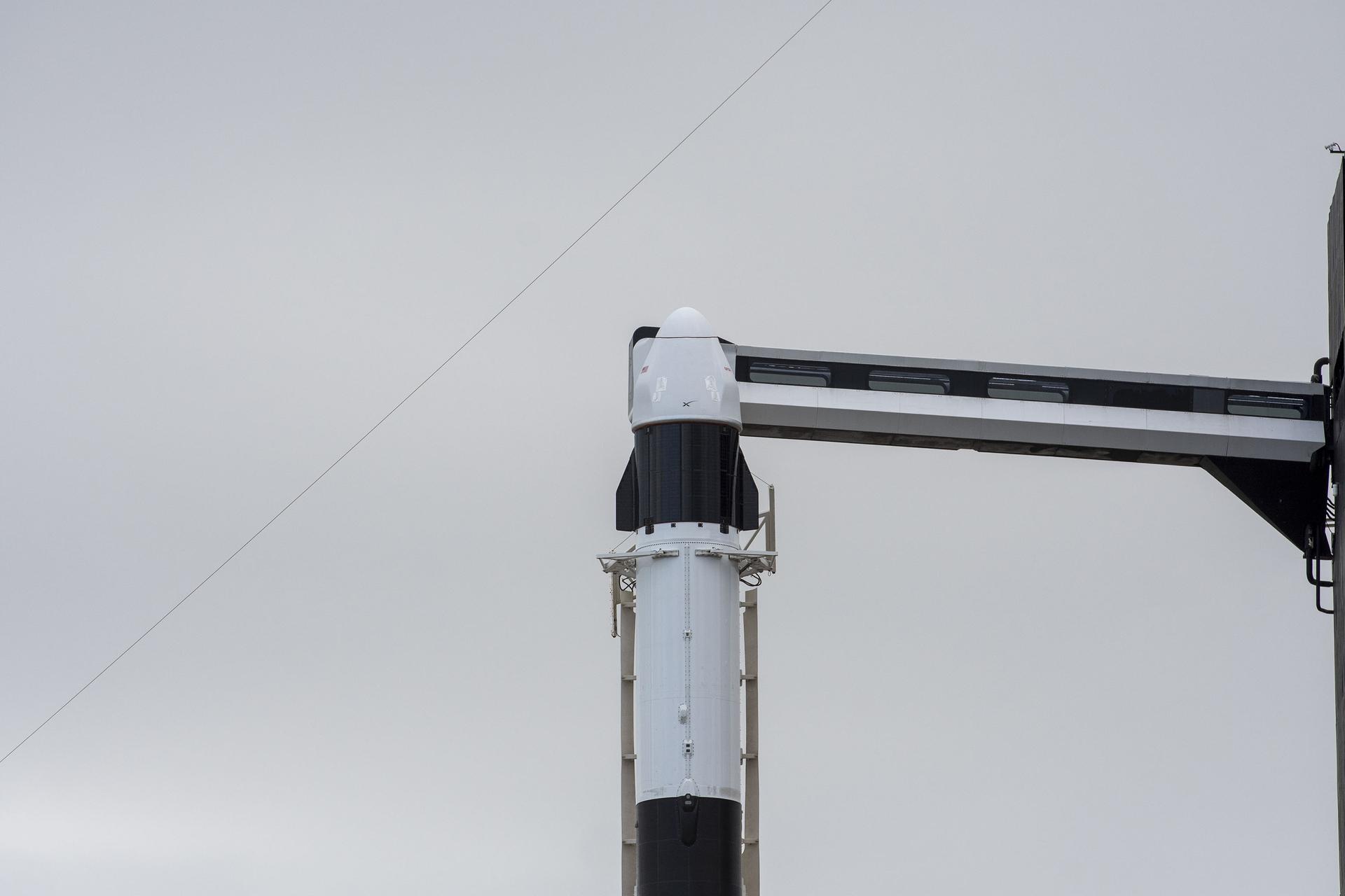 Seen here is the SpaceX Dragon cargo spacecraft atop the company's Falcon 9 rocket after being raised to a vertical position at NASA's Kennedy Space Center in Florida on Nov. 21, 2022, in preparation for the 26th commercial resupply services launch to the International Space Station. The mission will deliver new science investigations, supplies, and equipment to the crew aboard the space station, including the next pair of ISS Roll Out Solar Arrays (iROSAs).