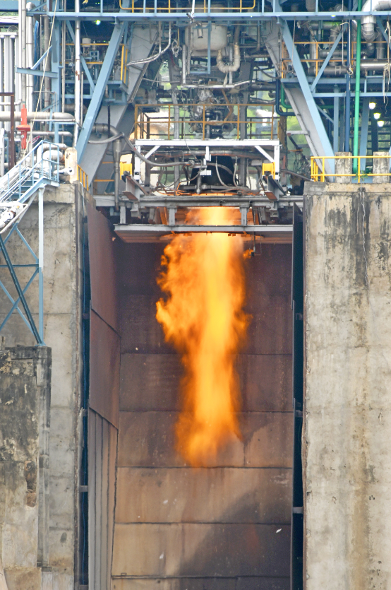Preparing for inflight re-ignition, full nozzle cryogenic engine (CE20) undergoes test outside vacuum chamber.